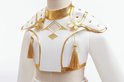 Details van de witte top met goudkleurige kraag, schoudervullingen met studs en gouden kwastjes.