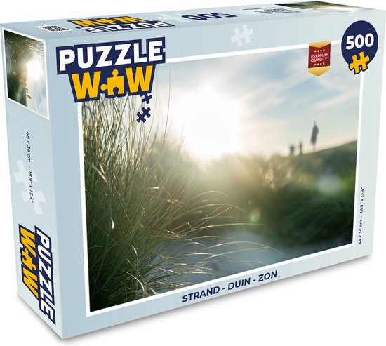 Boîte d'un puzzle de 500 pièces représentant un coucher de soleil sur la plage, des dunes et un ciel ensoleillé.