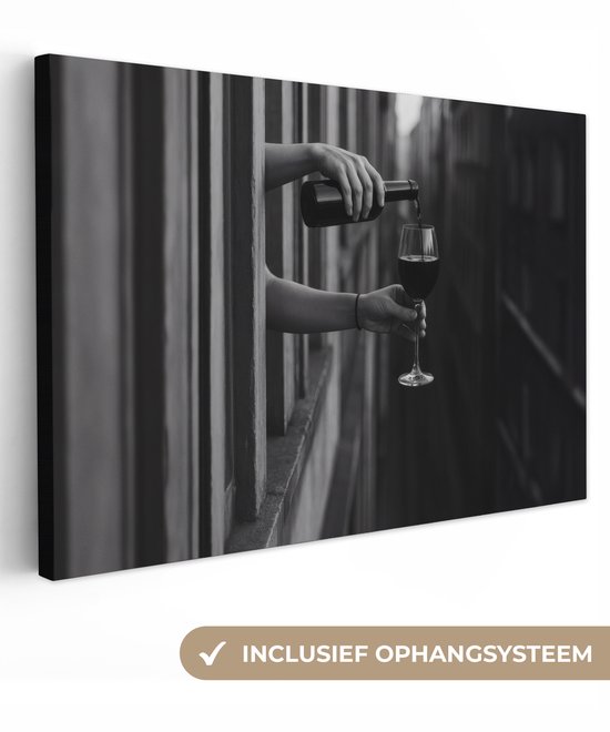 Zwart-wit canvas van handen die wijn schenken, inclusief ophangsysteem voor eenvoudige wandmontage.