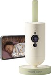 Philips Avent babyfoon met HD camera en standaard, naast een smartphone met beeld van slapende baby.