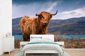 Behang - Fotobehang Schotse Hooglander - Berg - Water - Natuur - Koe - Breedte 330 cm x hoogte 220 cm