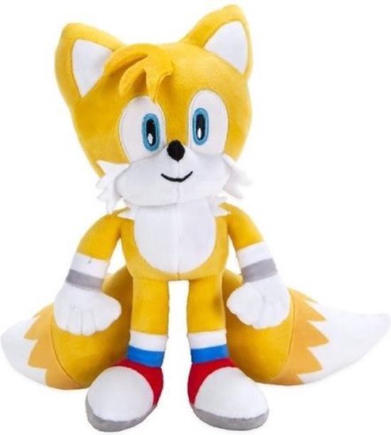 Gele pluche knuffel van Tails uit Sonic, met witte accenten en rode, witte en blauwe sokken.