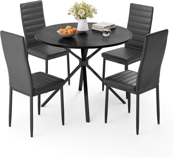 Zwarte ronde eettafel met vier zwarte gestreepte stoelen, versierd met bloemen en fruit.