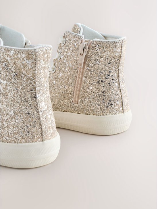 Gouden glitter hoge sneakers met roze rits aan de zijkant en witte zolen.