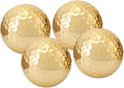 Vier glimmende gouden golfballen met dimplepatroon.