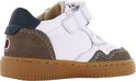 Zijkant van een witte leren babyschoen met bruine suède en donkerblauwe accenten.