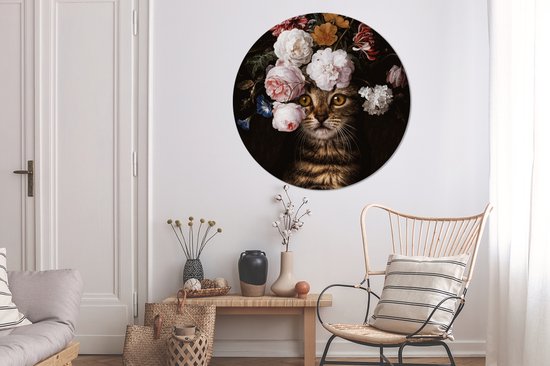 Ronde muurcirkel met kat met bloemenkrans, in een woonkamer met stoel en kast.