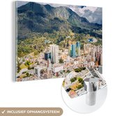 MuchoWow® Glasschilderij 90x60 cm - Schilderij acrylglas - De zon schijnt op het gebergte achter de Colombiaanse hoofdstad Bogota - Foto op glas - Schilderijen