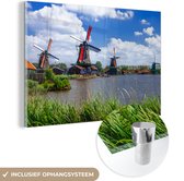 MuchoWow® Glasschilderij 60x40 cm - Schilderij acrylglas - Landschap met windmolens aan het water - Foto op glas - Schilderijen