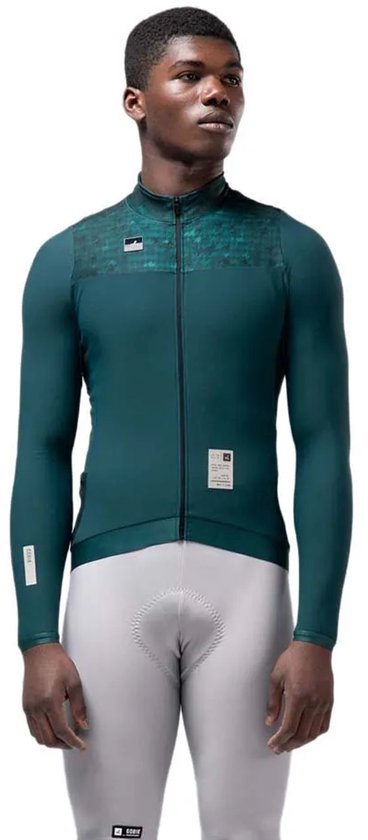 Donkergroen fietsshirt met lange mouwen, rits aan de voorzijde en geborduurd kraagdetail. Model toont de voorkant.