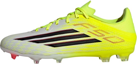 Zijaanzicht van een witte voetbalschoen met neongele accenten, zwarte strepen en rode details. Neongele veters en hak.
