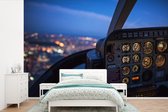 Behang - Fotobehang Cockpit van een vliegtuig in de nacht - Breedte 525 cm x hoogte 350 cm