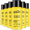 Groep van zes gele spuitbussen Got2b Glued Blasting Freeze Hairspray met zwarte doppen.