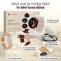 Luxe doos met gouden Siltcon Auréa 2 smartwatch, 5 verwisselbare bandjes, USB-oplaadkabel en gebruikershandleiding.