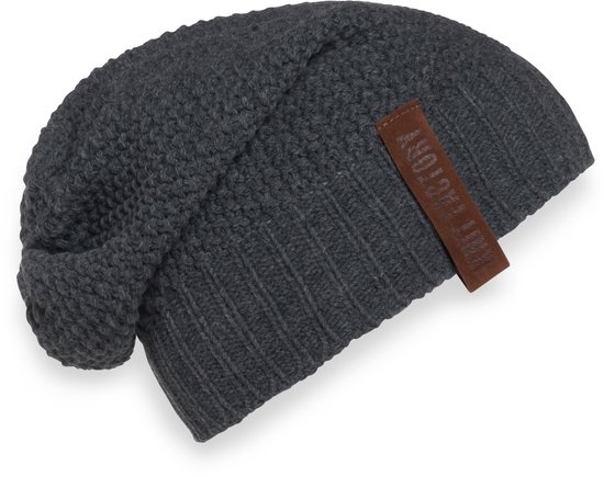 Donkergrijze gebreide beanie met bruin label.