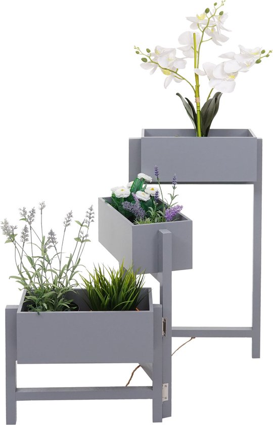 Grijze trapvormige plantenbak met witte orchideeën en lavendel.