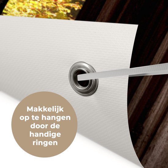 Detail van tuinposter met metalen ring, 'Makkelijk op te hangen door de handige ringen'.