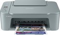 Grijze Canon Pixma printer met een New York City sightseeing brochure eruit.