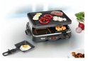 Compacte gourmetset met bakplaat met gegrild vlees en groenten, en pannetjes eronder.