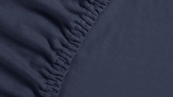 Donkerblauw jersey hoeslaken met elastische zoom.