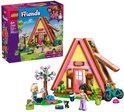 Lego Friends speelgoedhuisje met roze accenten, fiets en poppetjes, naast de doos met dezelfde afbeelding en de poppetjes.