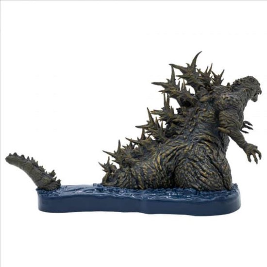 Godzilla figuur op een blauwe basis, met scherpe rugplaten en een staart die uit het water komt.