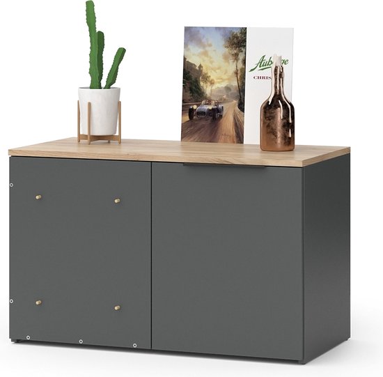 Antraciet dressoir met houten blad, versierd met een plant, een fles en een plaat.