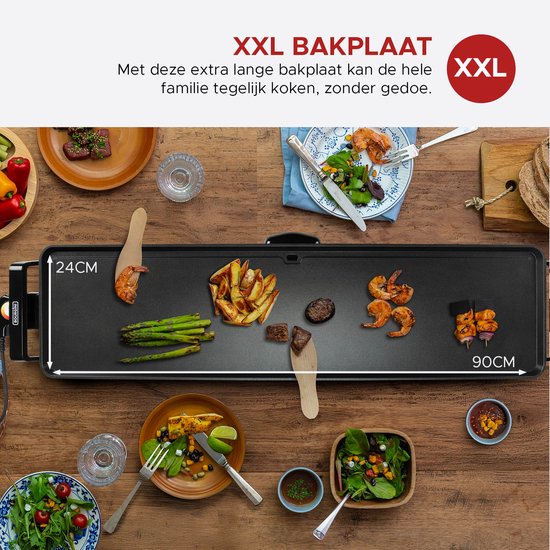 Een zwarte bakplaat van 90x24 cm met asperges, garnalen, friet en biefstuk.