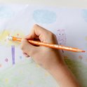 Hand kleurt met een oranje BIC Kids Illusion potlood een boom.