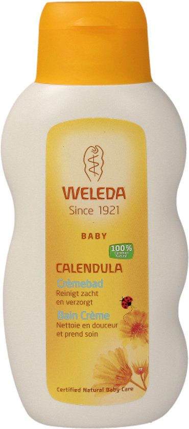 Witte fles met oranje dop van Weleda baby crèmebad, calendula. Gecertificeerde natuurlijke babyverzorging.