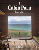 Boek 'Cabin Porn Inside' met een omslag waarop een woonkamer met uitzicht op de oceaan staat.