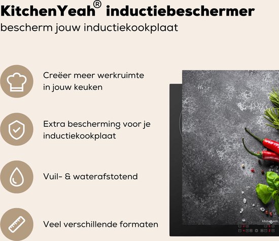 Zwarte inductiebeschermer met betonprint, met rode pepers, knoflook en kruiden. Biedt extra bescherming.