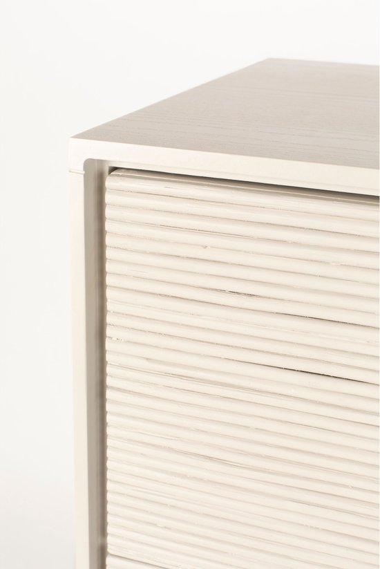 Gedeeltelijk zicht op de beige, geribbelde ladekast met focus op de textuur van de lades.