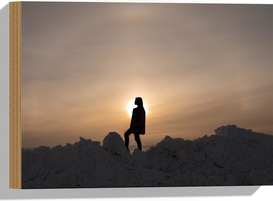 WallClassics - Hout - Vrouw Poserend op Hoop Sneeuw - 40x30 cm - 9 mm dik - Foto op Hout (Met Ophangsysteem)