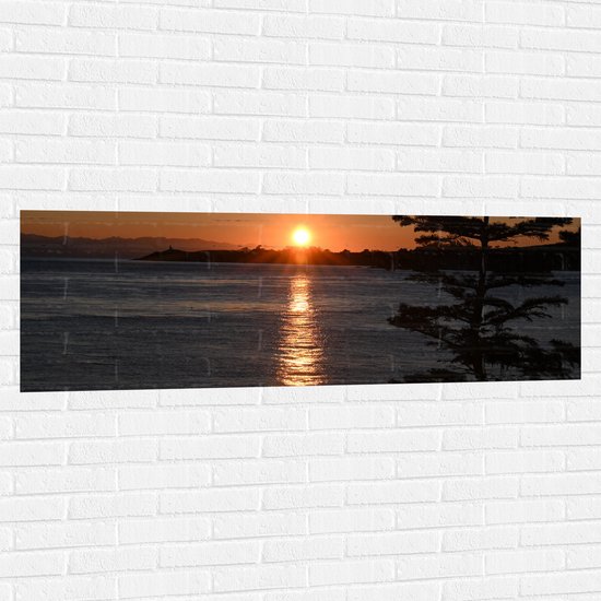 WallClassics - Muursticker - Zonsondergang bij het Water - 150x50 cm Foto op Muursticker