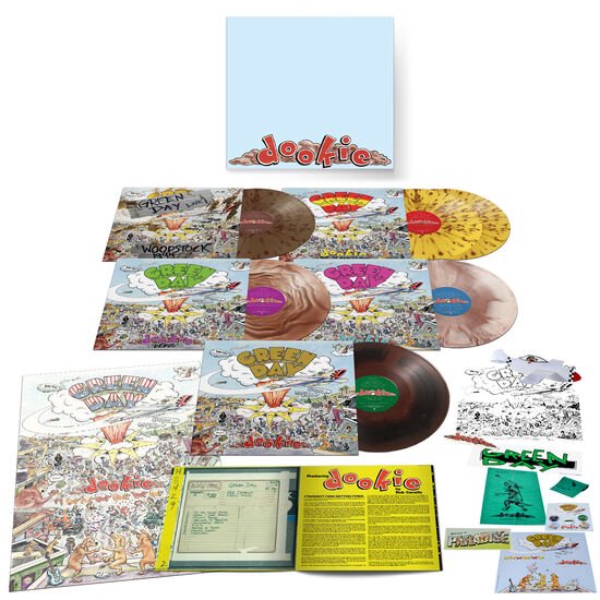 Dozen met gekleurde LP's, waaronder roze marmer, groen, geel gespikkeld, bruin en spiraalvormig. Ook met boekjes, posters en stickers.