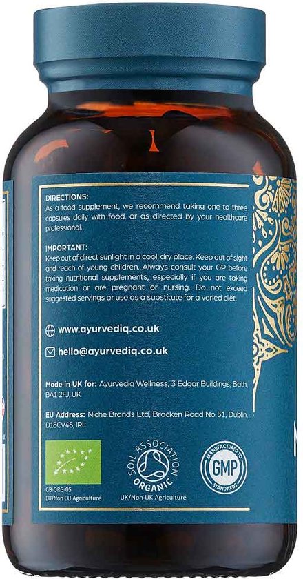 Bruine fles met blauw etiket met gouden ornamenten en productinformatie in het Engels, inclusief gebruiksinstructies en contactgegevens.