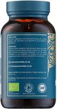 Bruine fles met blauw etiket met gouden ornamenten en productinformatie in het Engels, inclusief gebruiksinstructies en contactgegevens.