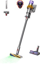 Dyson V15 Detect Absolute steelstofzuiger in nikkel en geel, met borstelkop die licht uitzendt en diverse accessoires.