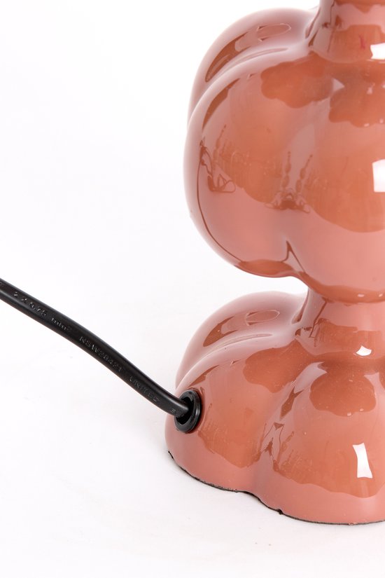 Base d'un pied de lampe orange avec un cordon noir sortant de la base.