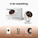 Verpakking van de gouden smartwatch met witte en roze bandjes, handleiding en USB-oplaadkabel. Inclusief de smartwatch zelf.