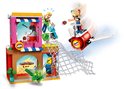 LEGO-scène: een meisje op een jetpack pakt een hamburger uit een roze met bruin gebouw, terwijl een ander meisje wordt aangevallen.
