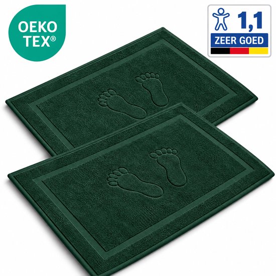 Set van twee donkergroene katoenen badmatten met een reliëf van voetafdrukken, OEKO-TEX gecertificeerd.