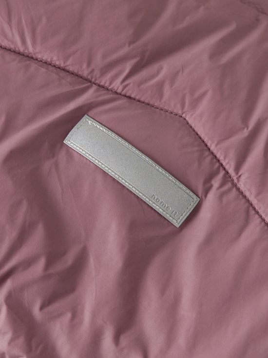 Detail van het reflecterende label met 'name it' tekst op de jas.