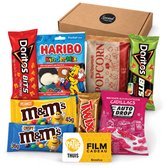 Een bruine kartonnen doos met een assortiment snacks zoals Doritos, M&M's, Haribo, popcorn en een Pathé Thuis kaart.