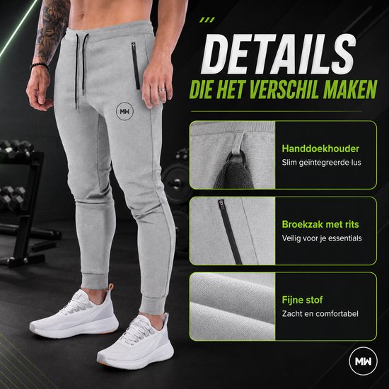 Grijze trainingsbroek met MW logo, ritszakken en trekkoord. Details: handdoekhouder, broekzak met rits, fijne stof. "Slim geïntegreerde lus, veilig voor je essentials, zacht en comfortabel".
