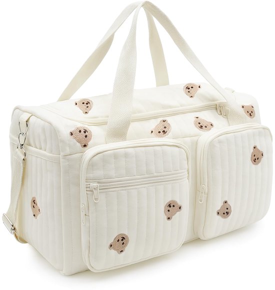 Sac à langer matelassé blanc avec broderies d'ours, fermetures éclair et poches ouvertes.