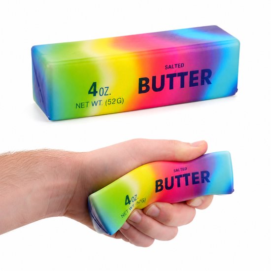 Een regenboog boterblok squishy in een hand, met "SALTED BUTTER 4 OZ NET WT. (52 G)"