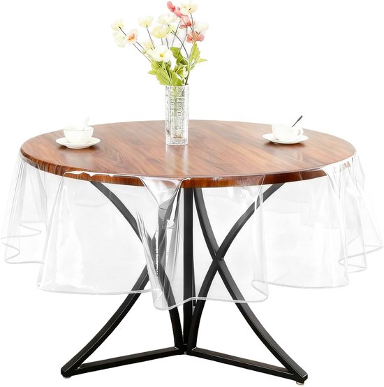 Nappe ronde transparente à bord ondulé sur une table en bois avec pied en métal noir.