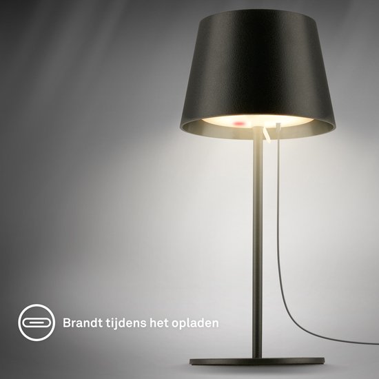 Lampe de table noire avec câble de chargement, allumée pendant la charge.